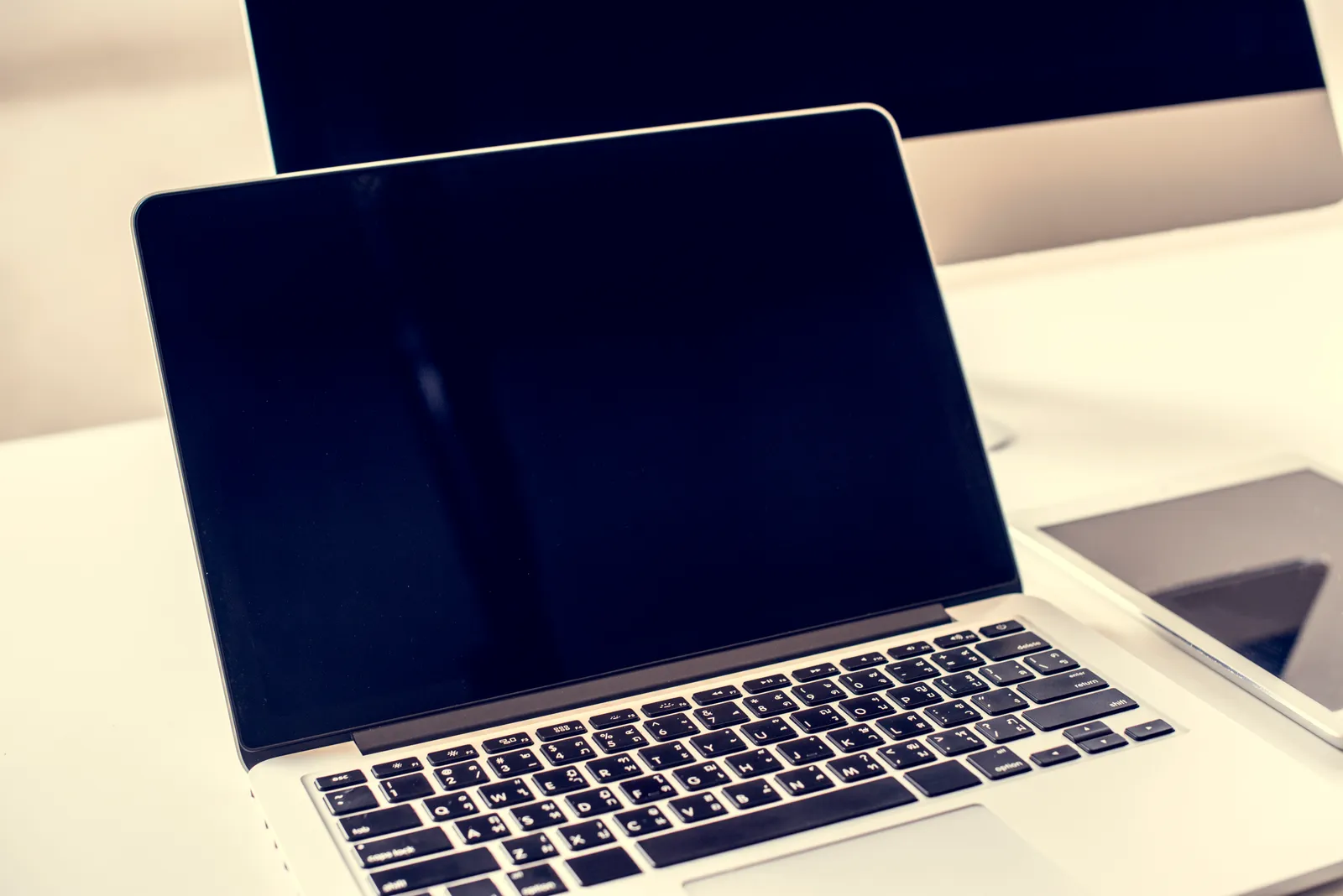 Laptop mockup on a desk, used as a placeholder image for an article comparing website platforms